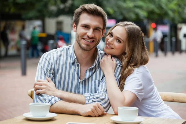 Casal feliz sentado no café calçada — Fotografia de Stock