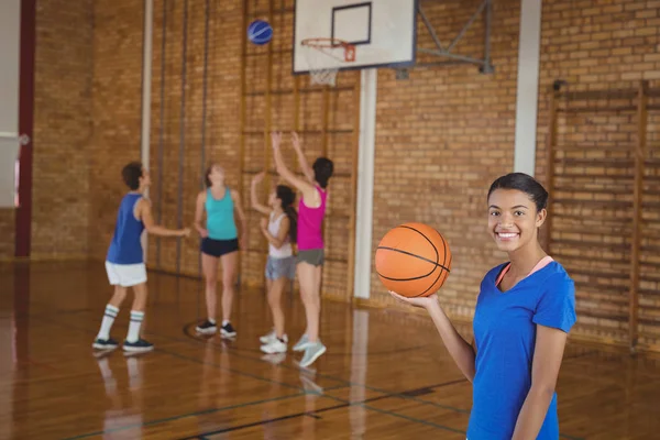 High school girl holding a basketball — Stock Photo, Image