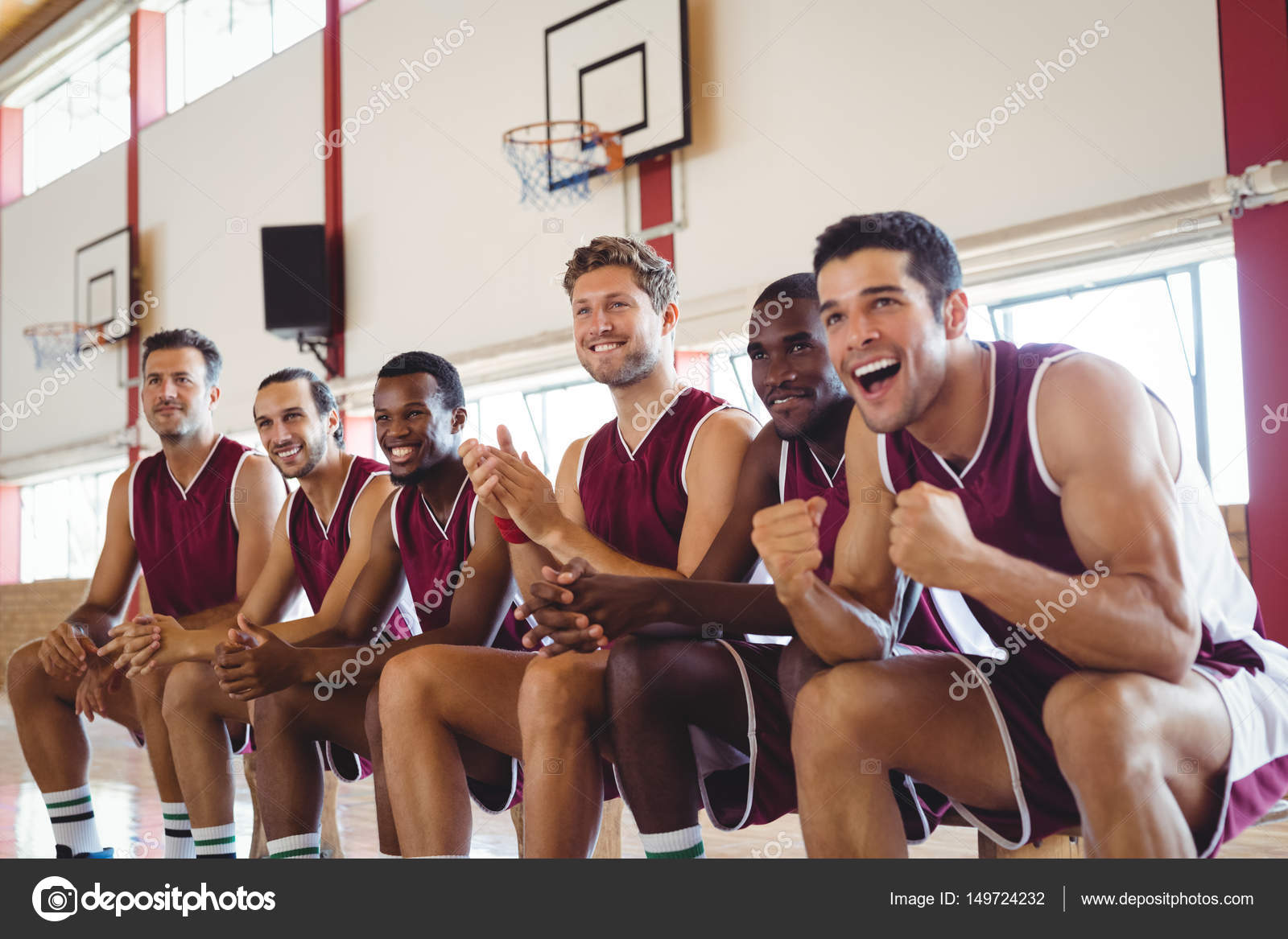Excited basketball player sitting on bench — Stock Photo