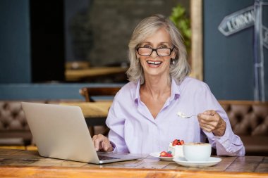 senior woman using laptop computer clipart