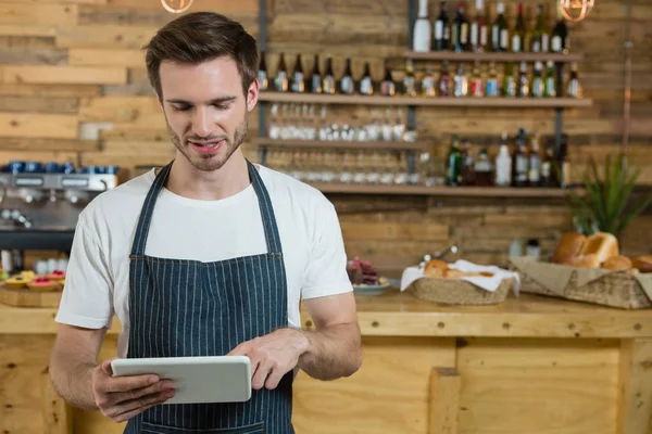 Kellner mit digitalem Tablet am Tresen — Stockfoto