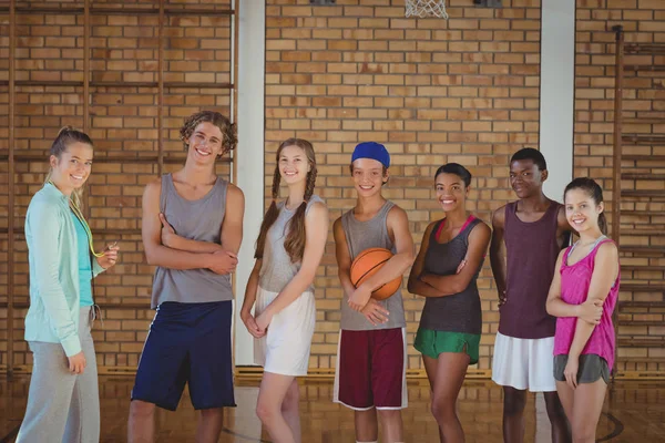 coach and high school kids in basketball court