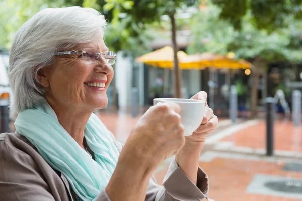 Senior vrouw met een koffiekopje — Stockfoto