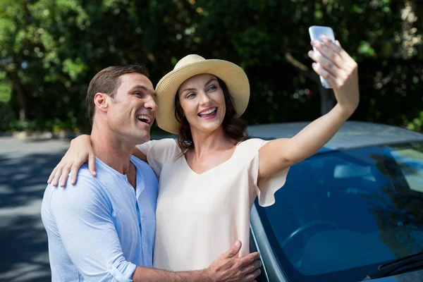 Pareja tomando selfie en coche — Foto de Stock