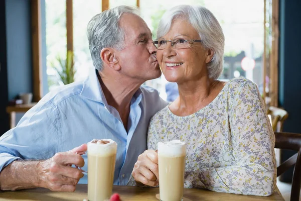 Senior man kissing senior woman — Stock Photo, Image