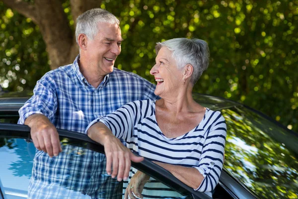 Senior paar leunend op auto deur — Stockfoto