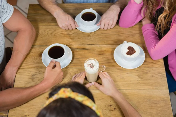 Przyjaciele filiżankę kawy w tabeli — Zdjęcie stockowe