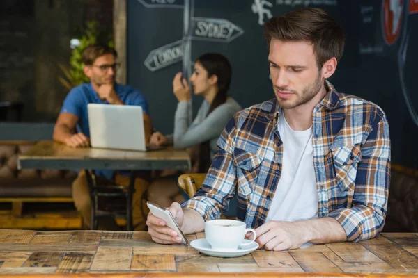 Ember használ mozgatható telefon, miközben kávét — Stock Fotó