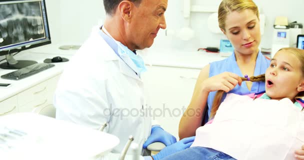 Zahnarzt interagiert mit jungen Patienten — Stockvideo