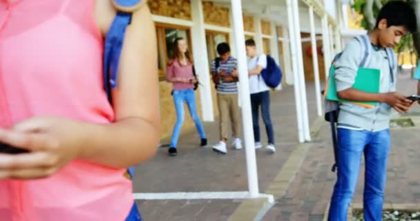 Schoolgirls using mobile phone — Stock Video