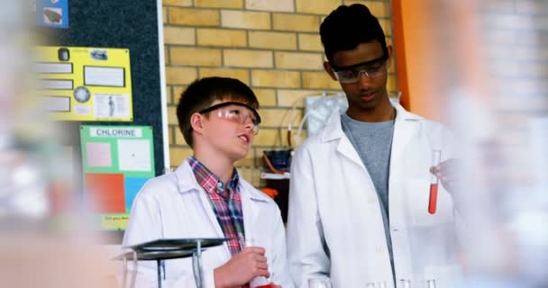 Uppmärksamma skolbarnen gör en kemiska experiment i laboratoriet — Stockvideo