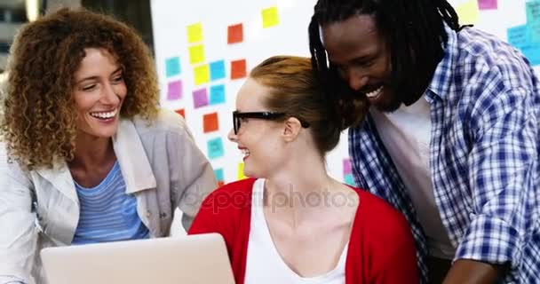 Ejecutivos felices hablando mientras trabajan en el portátil — Vídeos de Stock