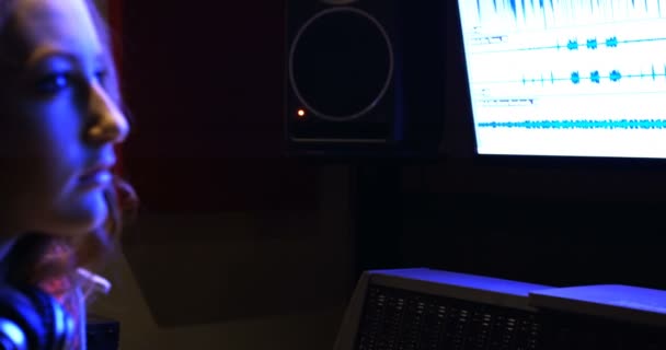 Tontechnikerin blickt auf Computerbildschirm — Stockvideo