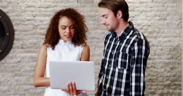 Executivos masculinos e femininos discutindo sobre laptop — Vídeo de Stock