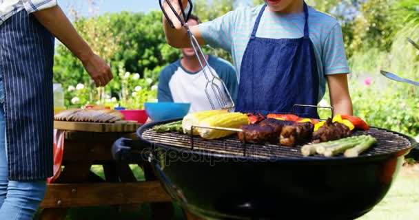 Kids grilling meat and vegetables on barbecue — Stock Video