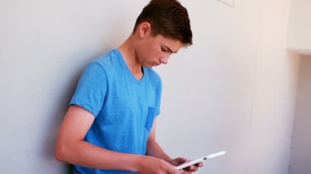 Attentive schoolboy using digital tablet — Stock Video