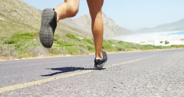 Triathlete man jogging in the countryside road — Stock Video