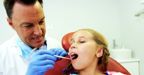 Dentist examining a young patient with tools — Stock Video