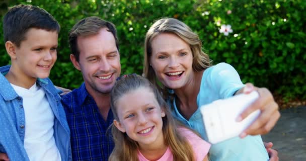 Familia feliz tomando selfie en el teléfono móvil en el parque — Vídeos de Stock