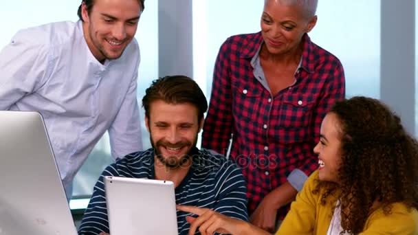 Felices colegas discutiendo sobre la tableta digital en el escritorio — Vídeos de Stock