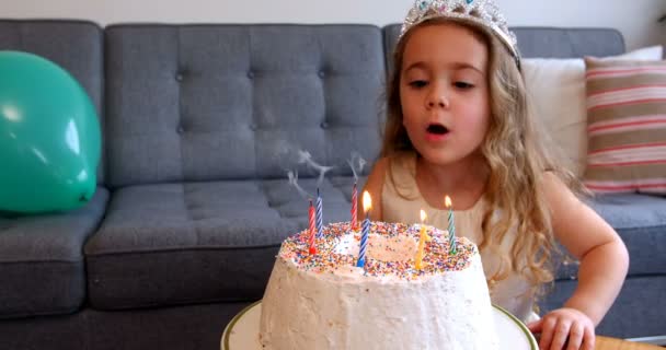 Girl blowing candles on birthday cake — Stock Video