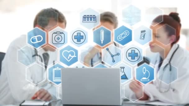 Doctors team discussing over laptop various icons — Stock Video