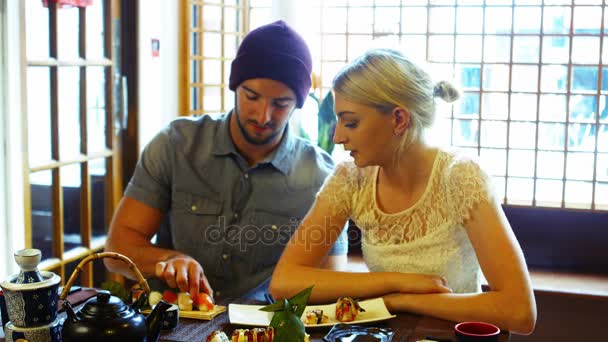 Man feeding sushi to woman — Stock Video