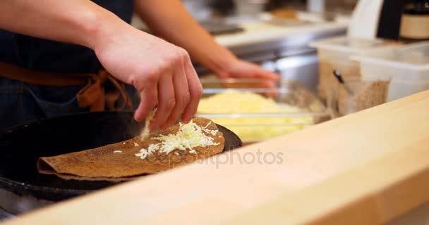 Chef espolvoreando queso sobre crepe — Vídeo de stock