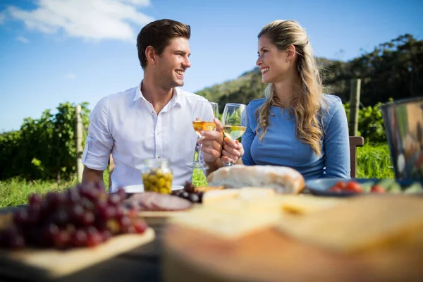 Paar kijken elkaar terwijl wijnglazen — Stockfoto