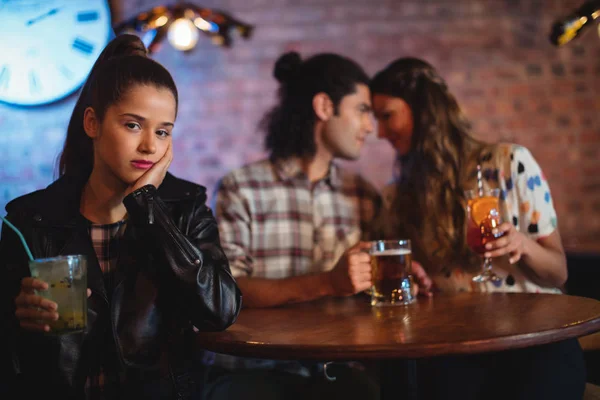 Upset woman ignoring affectionate couple — Stock Photo, Image