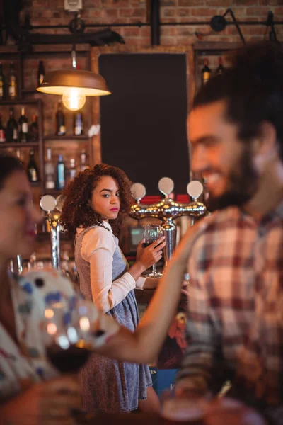 Jealous woman looking at couple flirting — Stock Photo, Image