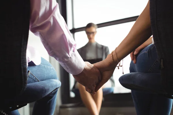 Mid section of couple holding hands — Stock Photo, Image