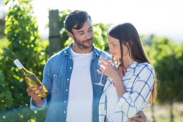 Man looking at girlfriend drinking wine — Stock Photo, Image