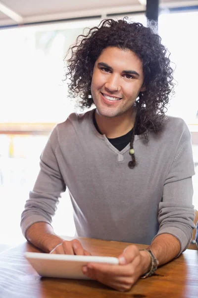 Smiling young man using tablet pc — Stock Photo, Image