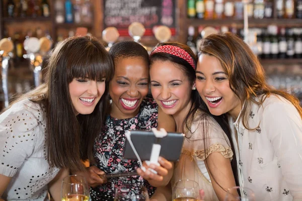 Cheerful female friends taking selfie in pub — Stock Photo, Image