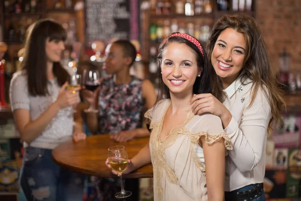 Smiling female friends in pub — Stock Photo, Image