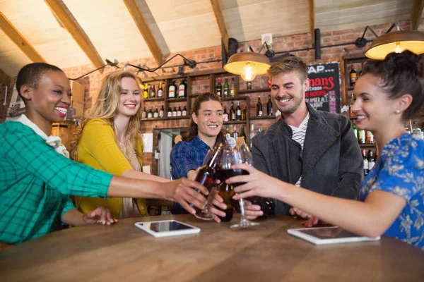 Friends toasting beer bottles and wine glasses — Stock Photo, Image