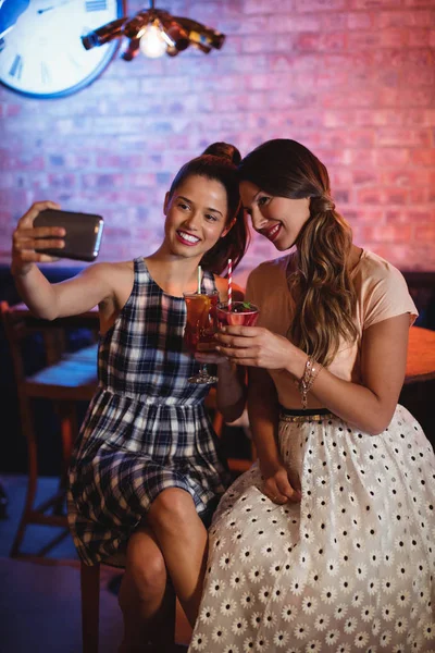 Mulheres que tomam selfie enquanto tomam coquetéis — Fotografia de Stock