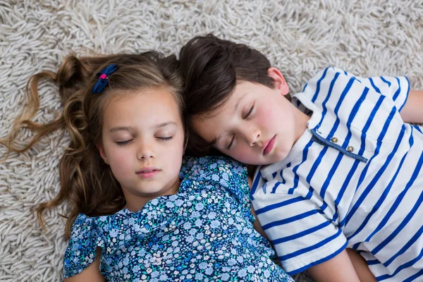 Rodzeństwo, spanie na dywanie w salonie — Zdjęcie stockowe