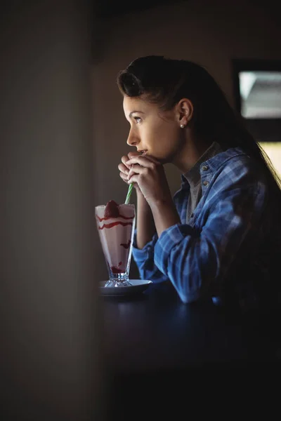 Thoughtful woman having milkshake — Stock Photo, Image