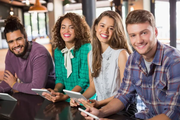 Friends holding digital tablets in restaurant — Stock Photo, Image