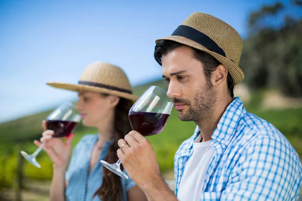 Thoughtful man smelling red wine in glass — Stock Photo, Image