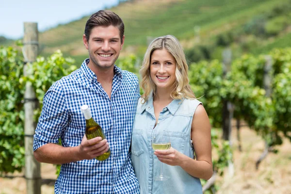 Couple holding wine bottle and glass — Stock Photo, Image