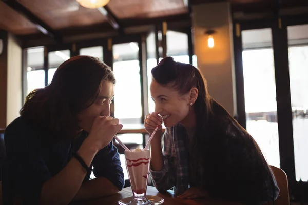 Happy couple having milkshake — Stock Photo, Image