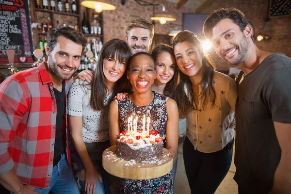 Friends holding birthday cake — Stock Photo, Image