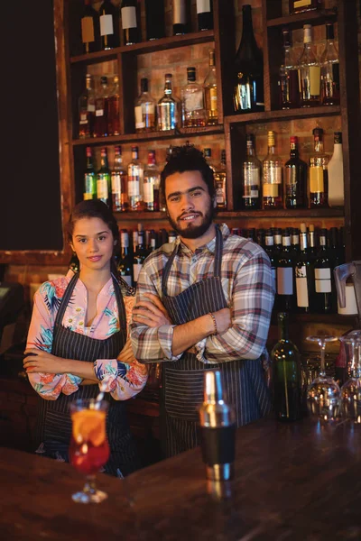 Waiter and waitress standing with arms crossed — Stock Photo, Image