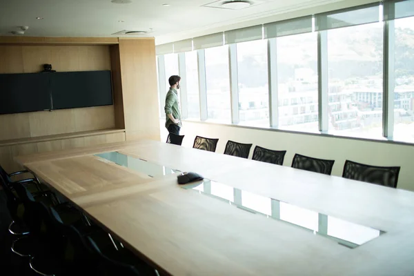 Businessman looking through window — Stock Photo, Image