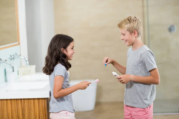 Broers en zussen interactie tijdens het tandenpoetsen — Stockfoto