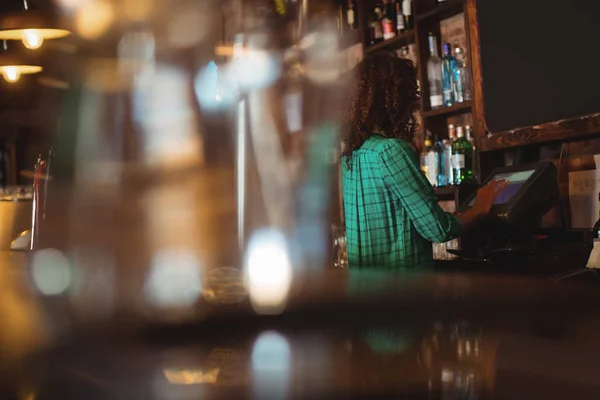 Female bar tender using electronic machine — Stock Photo, Image