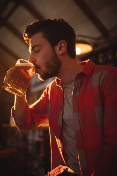 Young man having mug of beer — Stock Photo, Image